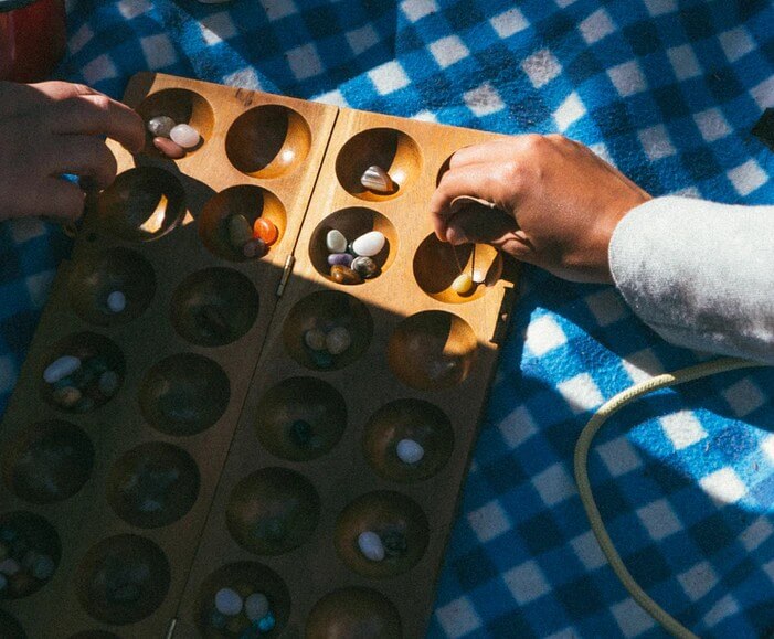 two people playing mancala