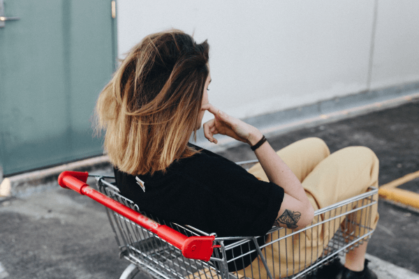 woman with tattoo inside a shopping cart