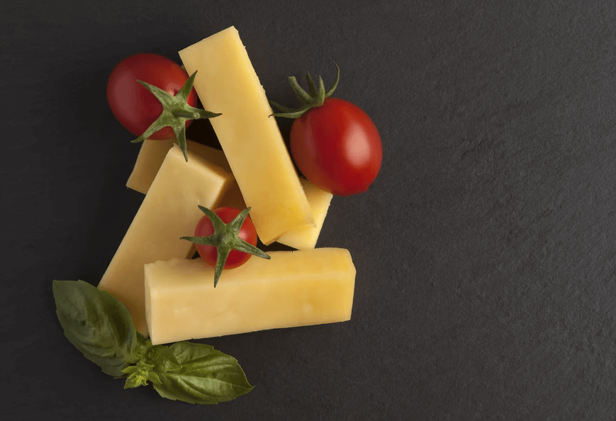 cheese, tomatoes and basil on a black background
