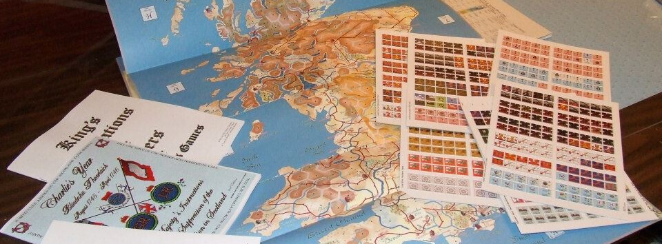 Charlie's Year wargame maps, counter sheets, and rules on a wooden table