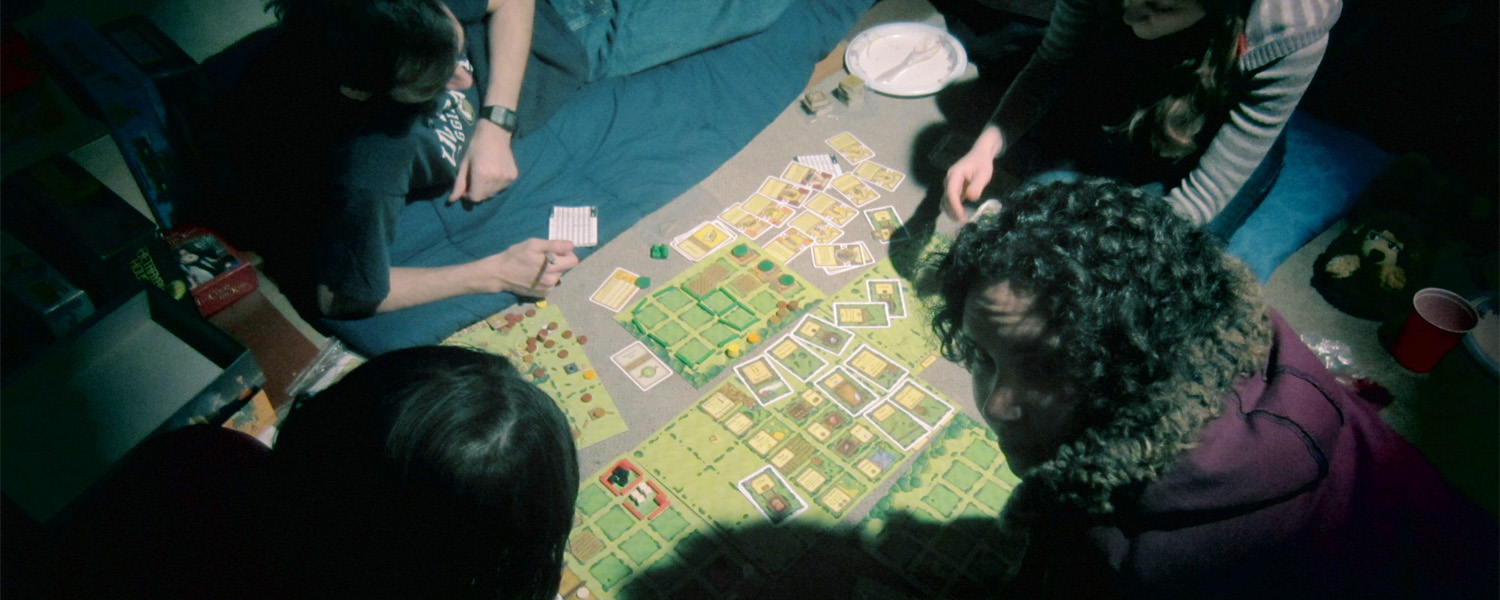 agricola board game setup with people around it