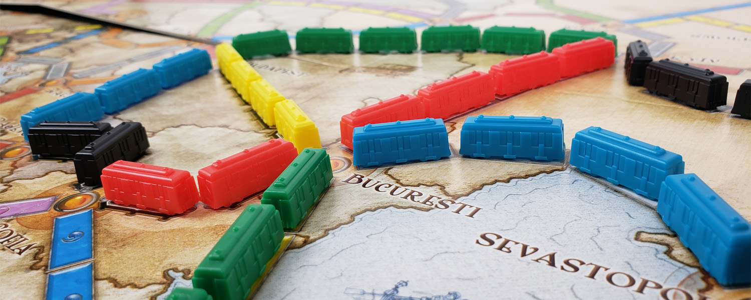 train car game pieces placed on the game board of euro games ticket to ride