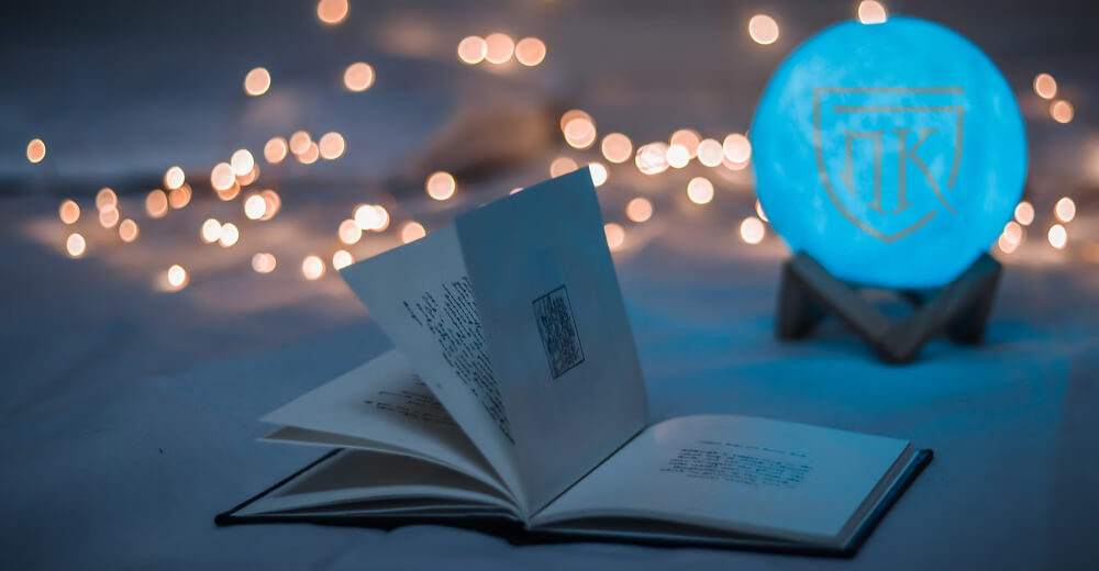 an open book with fairy lights and crystal ball in background