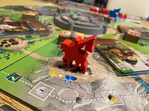 red wooden token sitting on the game board of the Viscount of the West Kingdoms board game from Renegade Game Studios