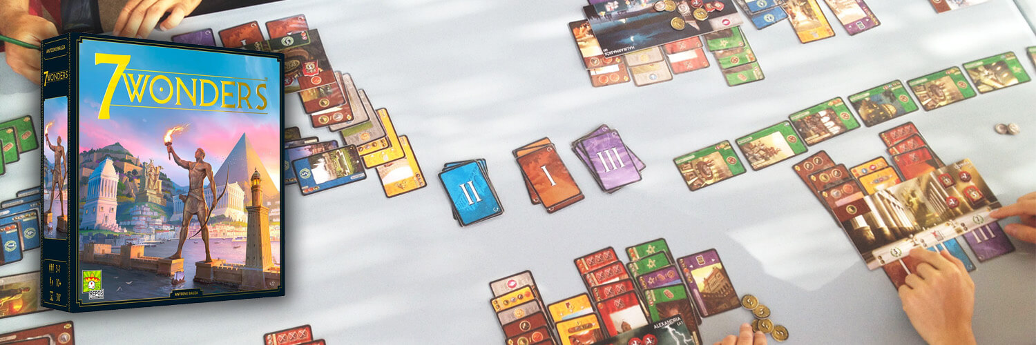 7 wonders board game box pictured over a table with the game being played