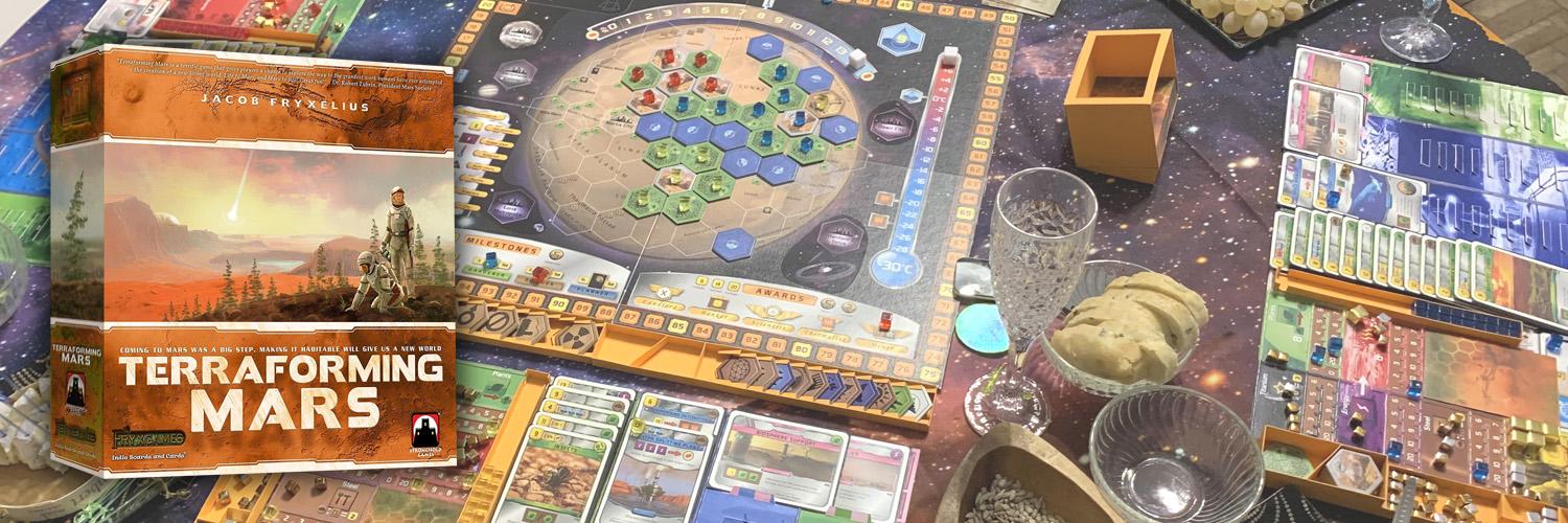 terraforming mars board game box set on a photo of the game board and components set up for play