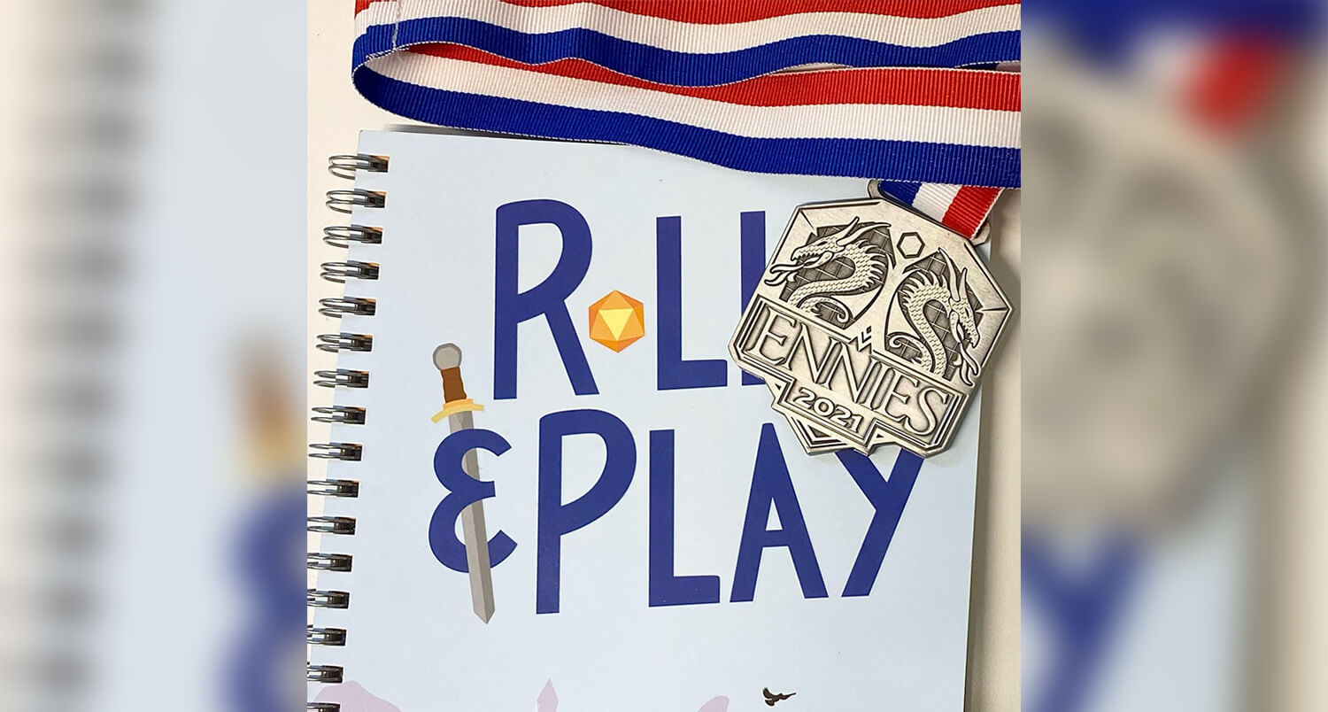 Roll & Play Press' 2021 Ennie Award laying on top of their Game Master's Fantasy Toolkit book