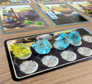 board game accessories, plastic game pieces on a card for the game Century - Golem Edition