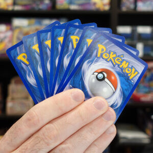 a hand of pokemon trading card game cards